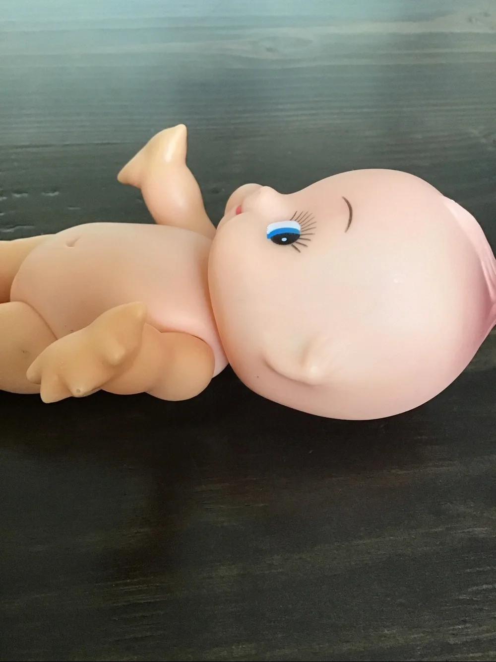Vintage unmarked 6-inch hard plastic Kewpie doll from the mid-century era